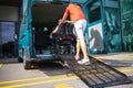 Disabled person on wheelchair using van ramp Royalty Free Stock Photo