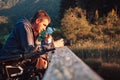 Disabled photographer taking a photo of mountain nature at dusk Royalty Free Stock Photo