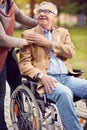 Disabled positive elderly man in wheelchair