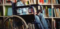 Disabled schoolboy using digital tablet in library Royalty Free Stock Photo