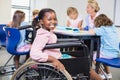 Disabled schoolgirl smiling in classroom