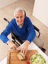 Disabled Senior Man Making Sandwich In Kitchen Royalty Free Stock Photo