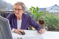 Disabled Senior woman consults a e-health doctor with tablet computer sitting on wheelchair . Royalty Free Stock Photo