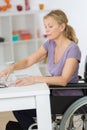 Disabled senior woman in wheelchair at home in living room Royalty Free Stock Photo