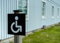 Disabled sign in front of building. Handicapped wheelchair access symbol
