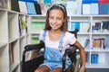 Disabled smiling schoolgirl in library