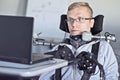 Disabled student working with his computer. Royalty Free Stock Photo
