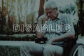 Disabled in Wheelchair. Pensively Sitting Retiree.