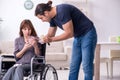 Disabled wife and young husband at home Royalty Free Stock Photo