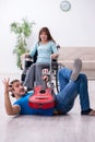 Disabled wife and young husband at home Royalty Free Stock Photo