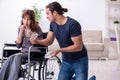 Disabled wife and young husband at home Royalty Free Stock Photo