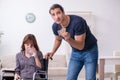 Disabled wife and young husband at home Royalty Free Stock Photo