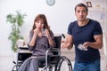 Disabled wife and young husband at home Royalty Free Stock Photo