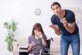 Disabled wife and young husband at home Royalty Free Stock Photo