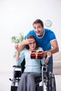 Disabled wife and young husband at home Royalty Free Stock Photo