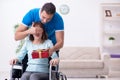 Disabled wife and young husband at home Royalty Free Stock Photo