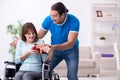 Disabled wife and young husband at home Royalty Free Stock Photo