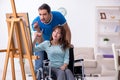 Disabled wife and young husband at home Royalty Free Stock Photo