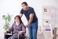 Disabled wife and young husband at home Royalty Free Stock Photo