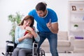 Disabled wife and young husband at home Royalty Free Stock Photo