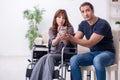 Disabled wife and young husband at home Royalty Free Stock Photo