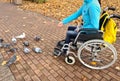 Disabled woman feeding pigeons while sitting in wheelchair Royalty Free Stock Photo