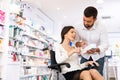 Disabled woman and her husband choosing medicine Royalty Free Stock Photo