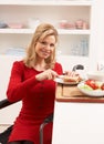 Disabled Woman Making Sandwich In Kitchen Royalty Free Stock Photo