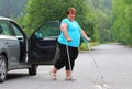 Disabled woman upgoing from a car. Royalty Free Stock Photo