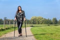 Disabled woman walks on crutches in nature