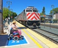 Disabled woman watching her train arrive