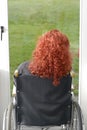 Disabled woman in wheelchair looking at the garden Royalty Free Stock Photo