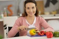 Disabled woman in wheelchair preparing meal in kitchen Royalty Free Stock Photo