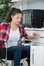 disabled woman in wheelchair preparing meal in kitchen Royalty Free Stock Photo