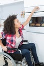 disabled woman in wheelchair preparing meal in kitchen Royalty Free Stock Photo