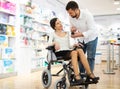 Disabled woman and her husband choosing medicine Royalty Free Stock Photo