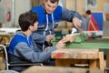 disabled worker in wheelchair in carpenters workshop with colleague Royalty Free Stock Photo