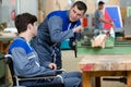 Disabled worker in wheelchair in factory Royalty Free Stock Photo
