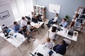 Disabled Young Businessman Giving Presentation To His Colleague Royalty Free Stock Photo