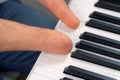 Disabled man with amputated two stump hands musician is playing piano. Royalty Free Stock Photo