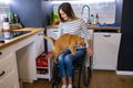 Woman in wheelchair in kitchen at home Royalty Free Stock Photo