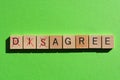 Disagree, word in 3d wood alphabet letters on green background