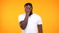 Disappointed afro-american male doing face palm gesture on yellow background Royalty Free Stock Photo