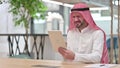 Disappointed Arab Businessman having Loss on Tablet