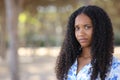 Disappointed black woman looking at camera in a park Royalty Free Stock Photo