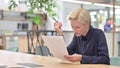 Disappointed Businesswoman feeling Shocked Reading Documents in Office