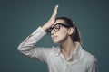 Disappointed confused woman doing a facepalm gesture Royalty Free Stock Photo