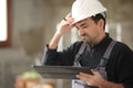 Disappointed construction worker checking tablet Royalty Free Stock Photo