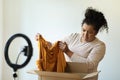 Disappointed customer fashion blogger unpacking parcel at home Royalty Free Stock Photo