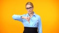 Disappointed female boss showing thumbs down, project failure, mistake gesture